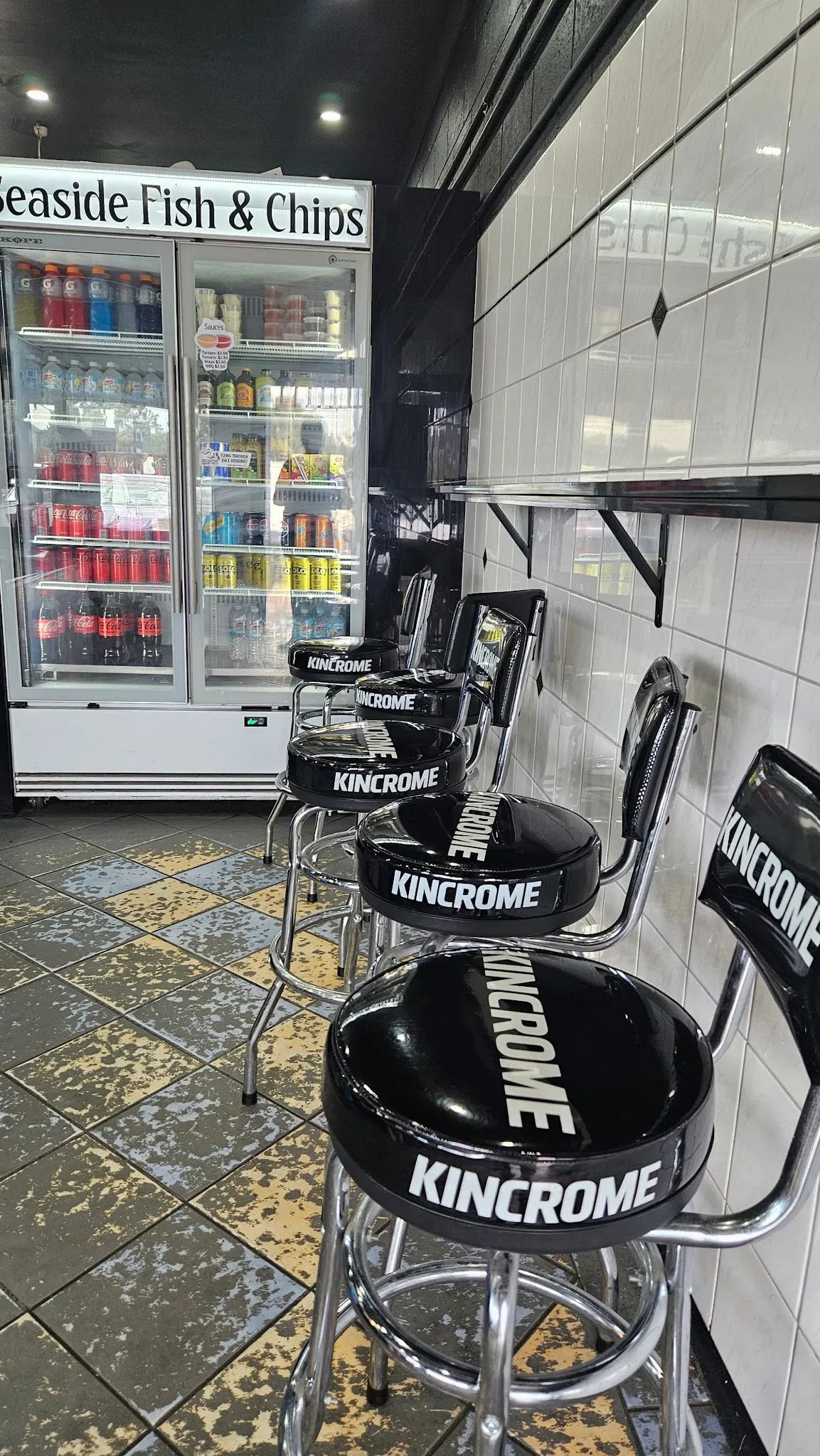 Interior of the shop with bar stools and the drinks fridge near the entrance